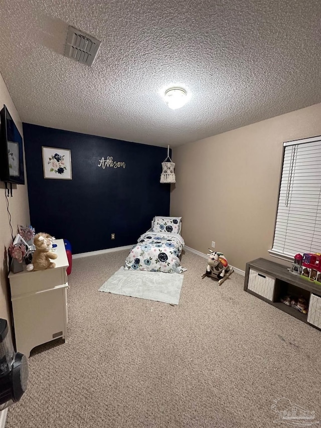 carpeted bedroom with a textured ceiling