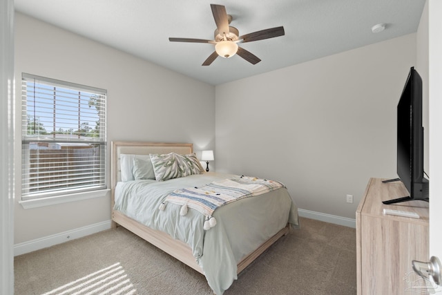 carpeted bedroom with baseboards and ceiling fan