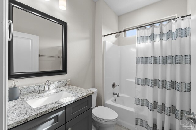 bathroom with vanity, toilet, and shower / tub combo