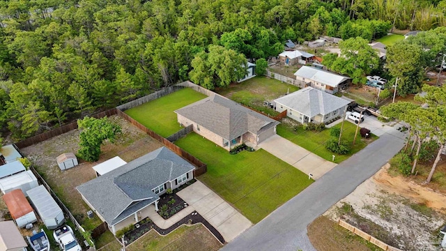 aerial view of residential area featuring a forest