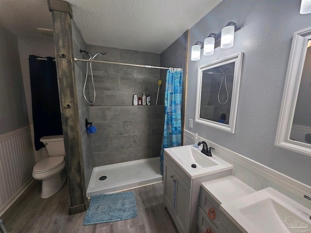 bathroom with a shower with shower curtain, wood-type flooring, toilet, and vanity