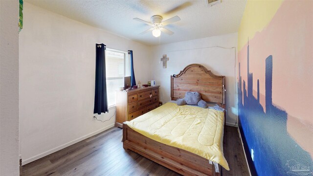 bedroom with dark wood-type flooring, a textured ceiling, and ceiling fan