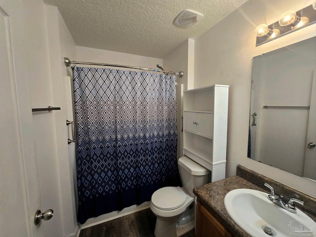 bathroom featuring toilet, vanity, a textured ceiling, wood-type flooring, and a shower with shower curtain