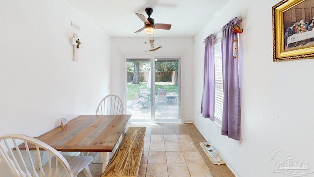 tiled dining space with ceiling fan