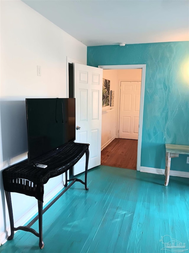 sitting room with wood finished floors and baseboards