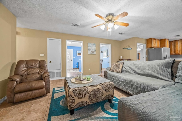 2762 Christine St, Pensacola, FL 32526 - living area featuring light tile patterned floors, a ceiling fan, a textured ceiling, and washer / dryer