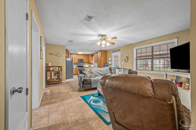 2762 Christine St, Pensacola, FL 32526 - living area featuring a ceiling fan, light tile patterned floors, and a textured ceiling