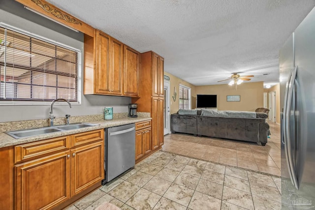 2762 Christine St, Pensacola, FL 32526 - kitchen featuring appliances with stainless steel finishes, a textured ceiling, open floor plan, a ceiling fan, and light countertops