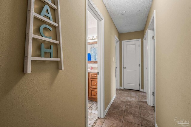 2762 Christine St, Pensacola, FL 32526 - corridor with a textured ceiling and tile patterned floors