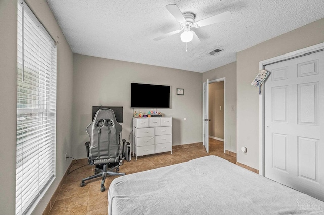 2762 Christine St, Pensacola, FL 32526 - bedroom with a textured ceiling, ceiling fan, and tile patterned flooring