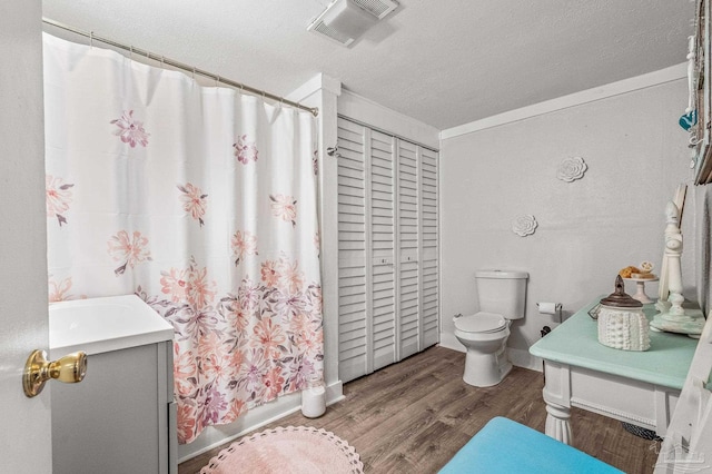 1220 E Cervantes, Pensacola, FL 32501 - full bath with toilet, wood finished floors, vanity, and a textured ceiling