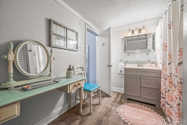 1220 E Cervantes, Pensacola, FL 32501 - bathroom featuring wood finished floors, a textured ceiling, and vanity
