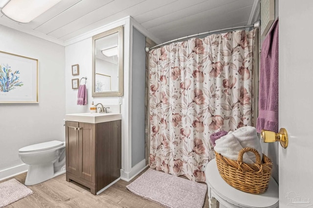 1220 E Cervantes, Pensacola, FL 32501 - bathroom featuring toilet, wood finished floors, vanity, curtained shower, and baseboards