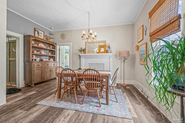 1220 E Cervantes, Pensacola, FL 32501 - dining room featuring dark wood-type flooring, a chandelier, crown molding, and baseboards