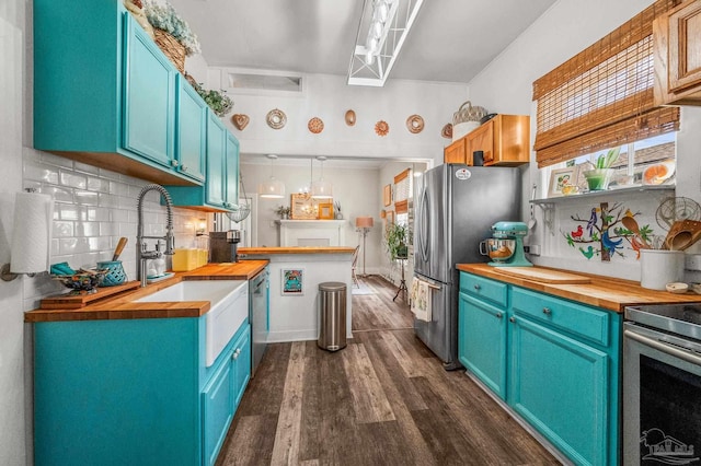 1220 E Cervantes, Pensacola, FL 32501 - kitchen featuring appliances with stainless steel finishes, wood counters, dark wood-style floors, and blue cabinets