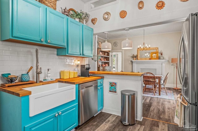 1220 E Cervantes, Pensacola, FL 32501 - kitchen featuring wooden counters, stainless steel appliances, dark wood-style floors, and tasteful backsplash