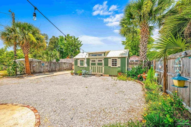 1220 E Cervantes, Pensacola, FL 32501 - back of property with metal roof, an outdoor structure, and a fenced backyard