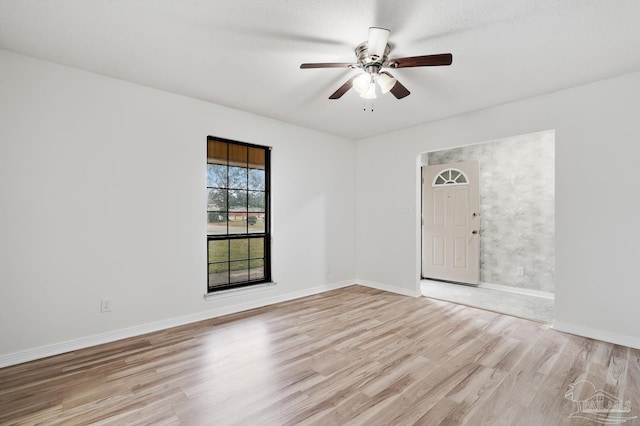 unfurnished room featuring ceiling fan and light wood-type flooring