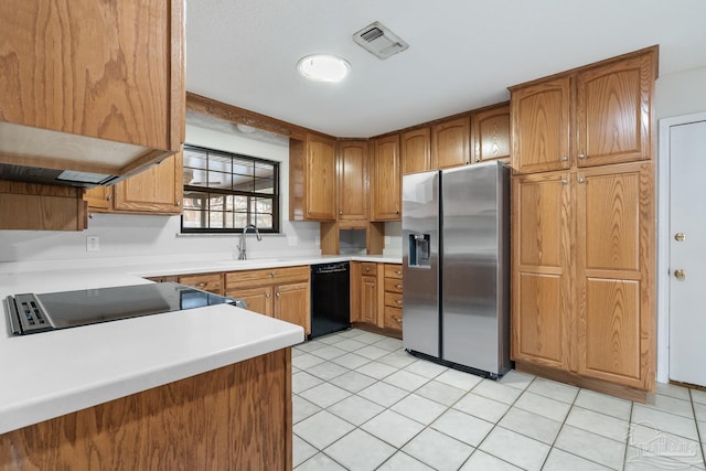 kitchen with black dishwasher, sink, stainless steel fridge, and light tile patterned floors