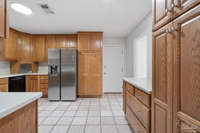 kitchen with stainless steel fridge, dishwasher, and light tile patterned floors