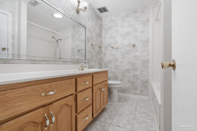 bathroom featuring vanity, tile patterned floors, and toilet