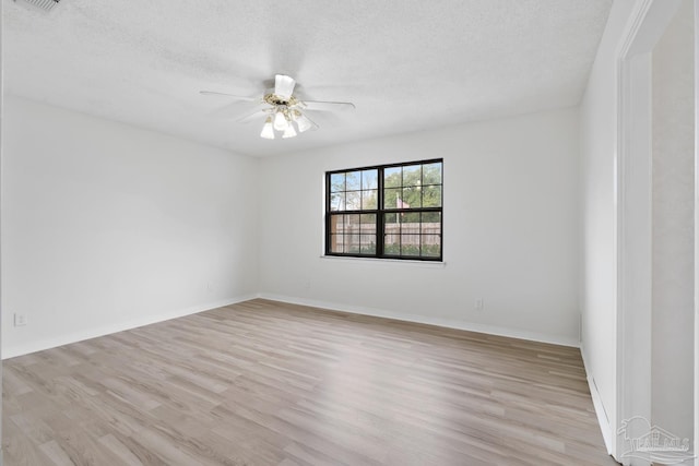 unfurnished room featuring ceiling fan, light hardwood / wood-style flooring, and a textured ceiling