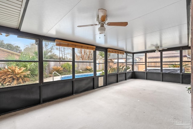 unfurnished sunroom featuring a healthy amount of sunlight and ceiling fan