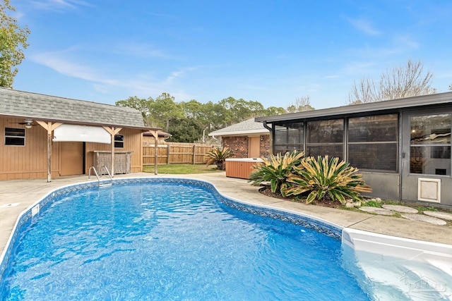 view of swimming pool featuring a sunroom and a patio