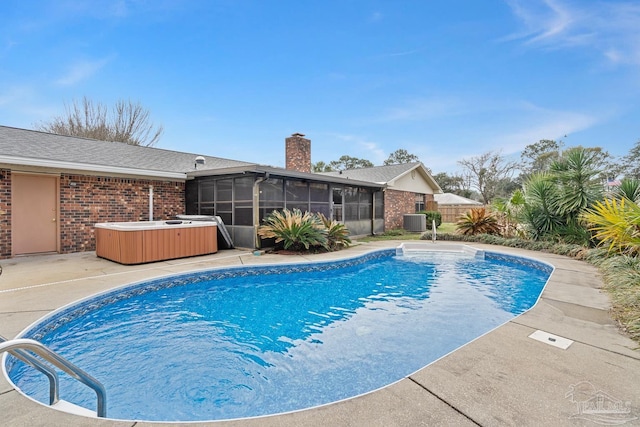 view of swimming pool featuring a hot tub, a sunroom, a patio area, and central air condition unit