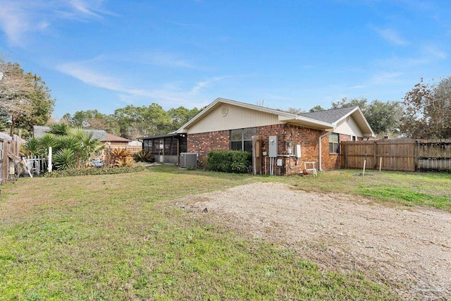 view of property exterior featuring cooling unit and a lawn