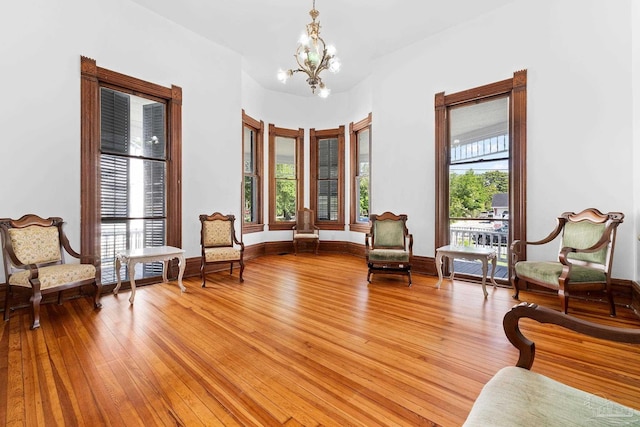 sitting room featuring an inviting chandelier and light hardwood / wood-style flooring