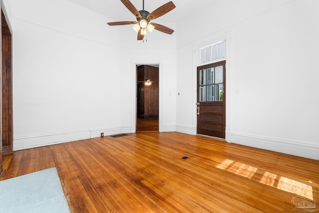 spare room with hardwood / wood-style flooring, ceiling fan, and high vaulted ceiling