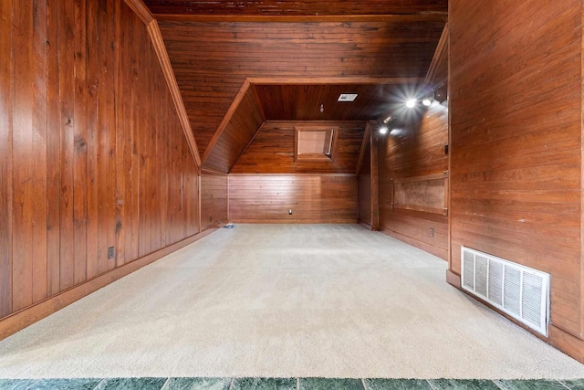 additional living space with wood walls, light carpet, and wooden ceiling