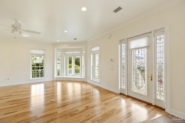 foyer featuring crown molding, ceiling fan, and light hardwood / wood-style flooring