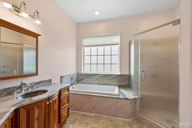 bathroom with shower with separate bathtub and vanity