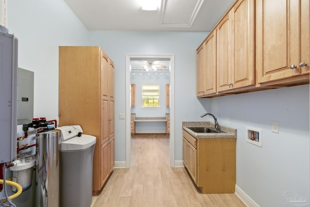 laundry area with cabinets, hookup for a washing machine, sink, and light hardwood / wood-style flooring