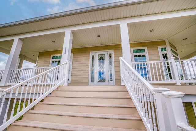 view of exterior entry featuring covered porch