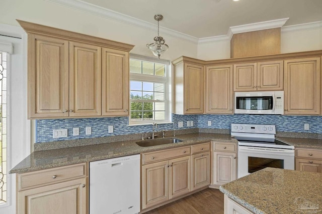 kitchen with sink, white appliances, ornamental molding, and hanging light fixtures