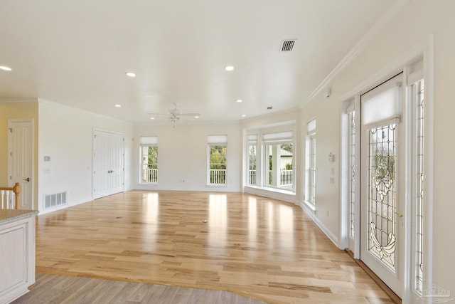 interior space featuring ornamental molding, light hardwood / wood-style floors, and ceiling fan