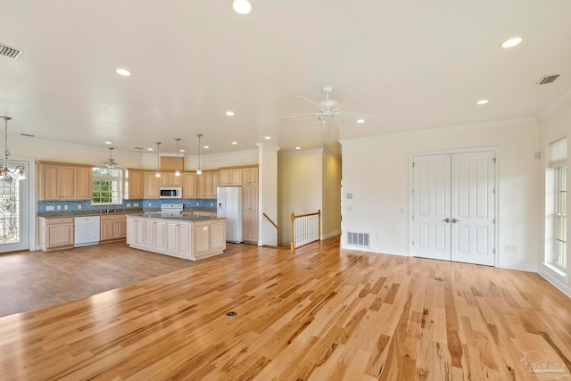 kitchen with pendant lighting, a center island, ceiling fan, and white appliances