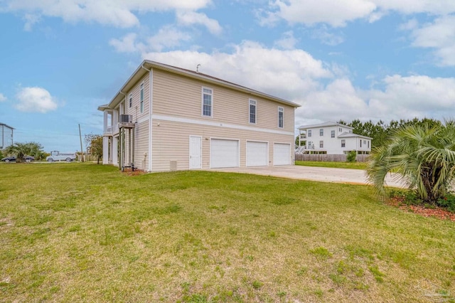 view of side of property featuring a lawn and a garage