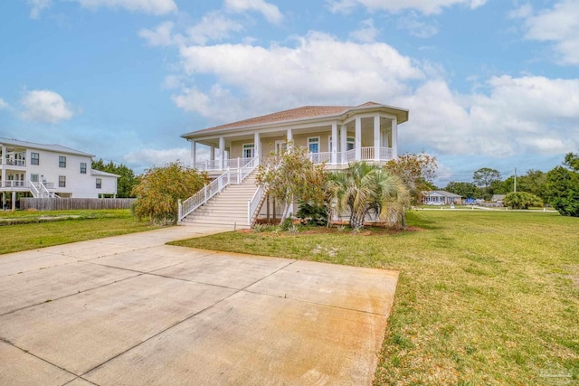 view of front of house featuring covered porch and a front lawn