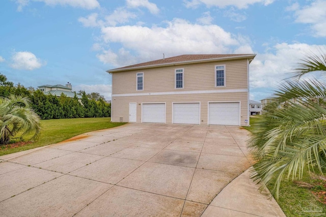 view of side of home featuring a garage and a yard