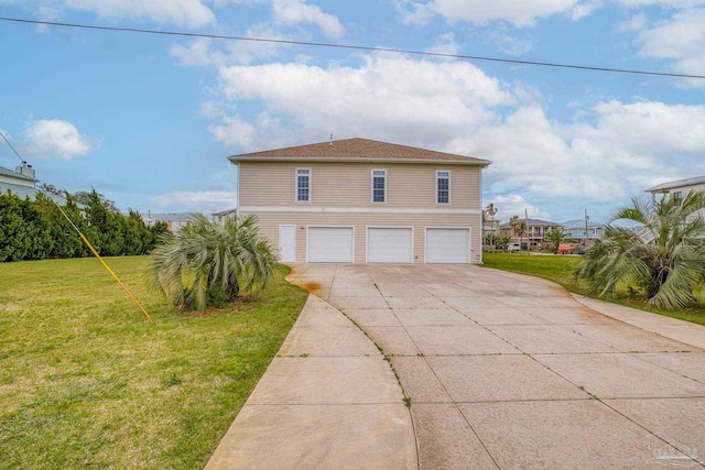 view of side of property featuring a garage and a lawn