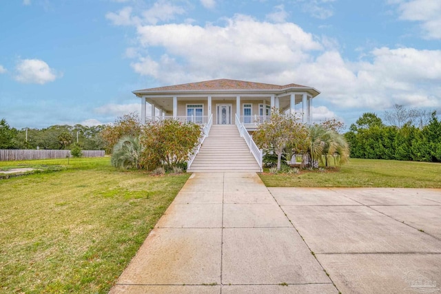 view of front of home featuring covered porch and a front lawn