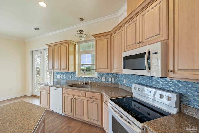 kitchen with light wood-type flooring, sink, white appliances, and tasteful backsplash