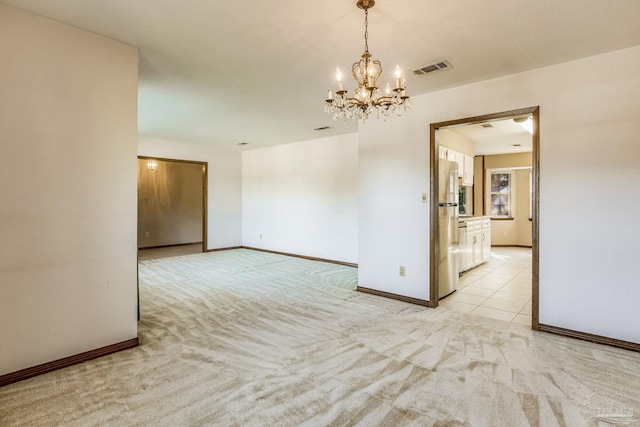 unfurnished room with light carpet and a notable chandelier