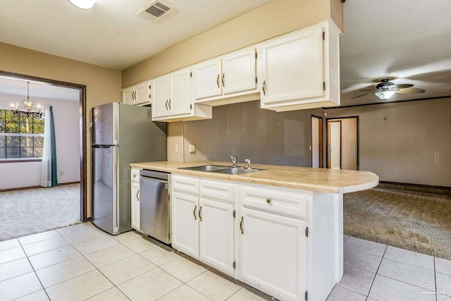 kitchen featuring light carpet, stainless steel dishwasher, ceiling fan with notable chandelier, sink, and white cabinets