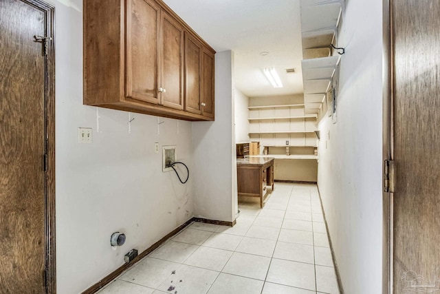 washroom featuring cabinets, washer hookup, and light tile patterned flooring