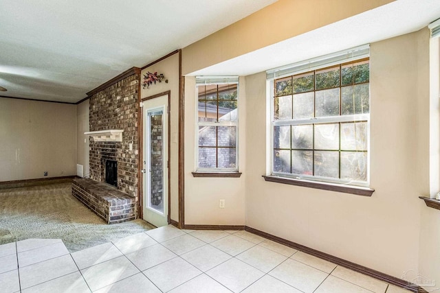 unfurnished living room with a fireplace and light tile patterned flooring